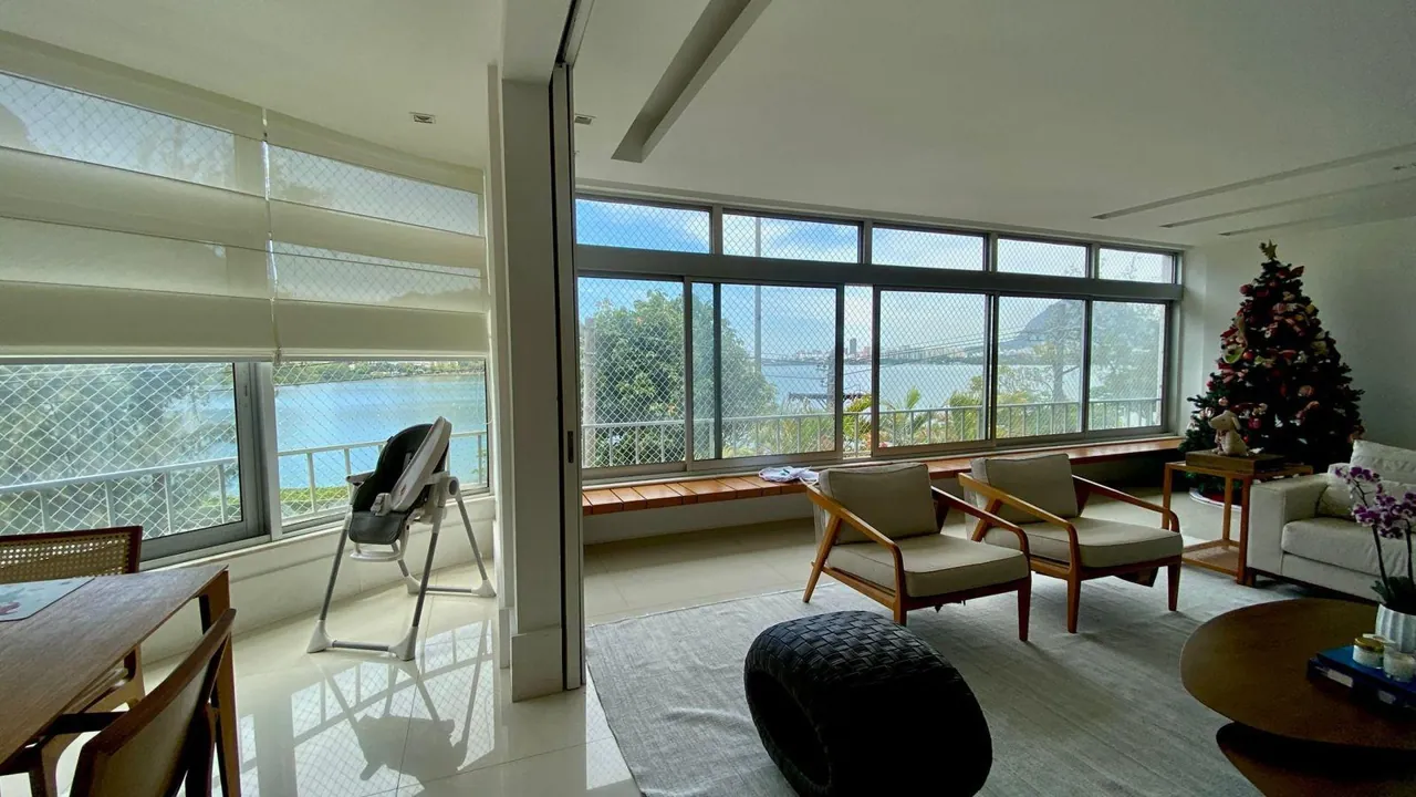 Sala de estar com poltronas e vista para a Lagoa