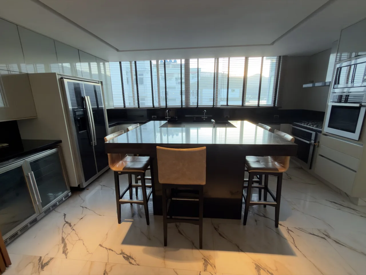 Cozinha planejada com ilha, geladeira duplex e adega